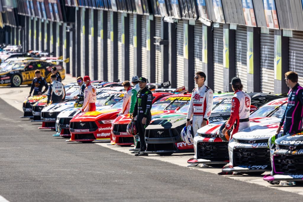 2024 Supercars Championship drivers pose with their cars in pit lane at Mount Panorama at the Bathurst 500 in February 2024