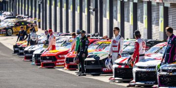 2024 Supercars Championship drivers pose with their cars in pit lane at Mount Panorama at the Bathurst 500 in February 2024