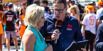 Fox Sports host Jessica Yates and commentator Mark Skaife stand on the grid at the 2023 Gold Coast 500