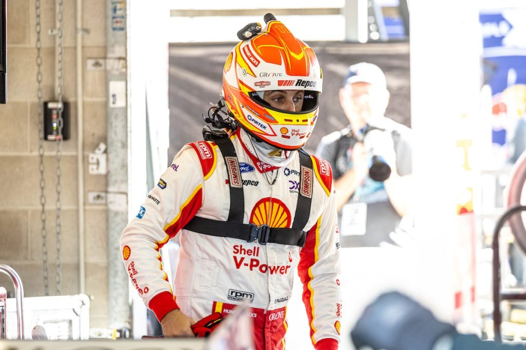 Anton De Pasquale stands in the Dick Johnson Racing garage at Townsville, wearing helmet and Simpson device