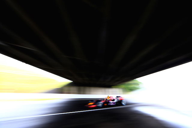 Daniil Kvyat running under the figure eight overpass after the second of the Degner Curves