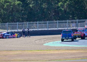 Recovery crews attend to Jamie Whincup's beached Camaro. Image: Richard Gresham