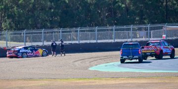 Recovery crews attend to Jamie Whincup's beached Camaro. Image: Richard Gresham