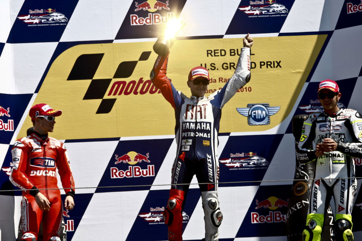 Jorge Lorenzo (centre, celebrating victory at Laguna Seca in 2012) sought out rivalries with the likes of fellow MotoGP champion Valentino Rossi (right)