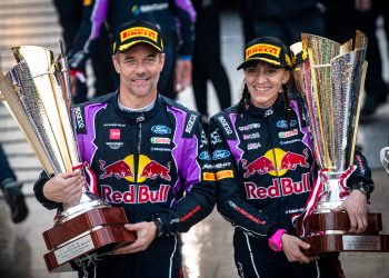 Sébastien Loeb (and Isabelle Galmiche of team M-Sport Ford World Rally Team celebrate on the podium after winning the 2022 Monte-Carlo Rally.