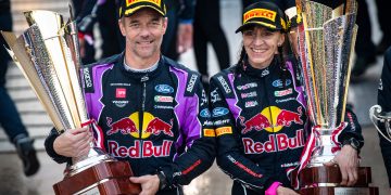 Sébastien Loeb (and Isabelle Galmiche of team M-Sport Ford World Rally Team celebrate on the podium after winning the 2022 Monte-Carlo Rally.