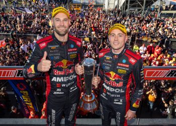 Shane van Gisbergen (left) with Richie Stanaway with the Peter Brock Trophy on the Mount Panorama podium.