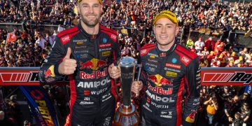 Shane van Gisbergen (left) with Richie Stanaway with the Peter Brock Trophy on the Mount Panorama podium.