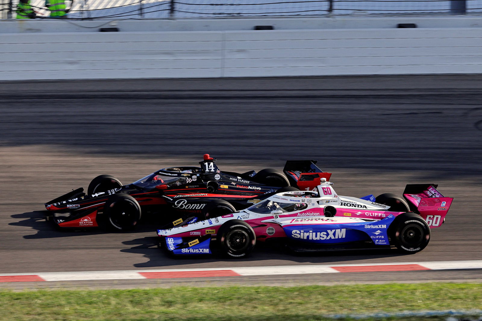 Meyer Shank Racing's Felix Rosenqvist in the #60 battles with AJ Foyt Racing's Santino Ferrucci at Iowa Speedway.