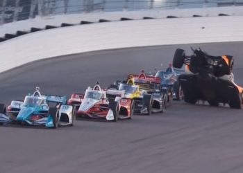 Alexander Rossi climbs over the back of Will Power's car on the second-to-last race restart at Gateway.