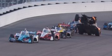 Alexander Rossi climbs over the back of Will Power's car on the second-to-last race restart at Gateway.