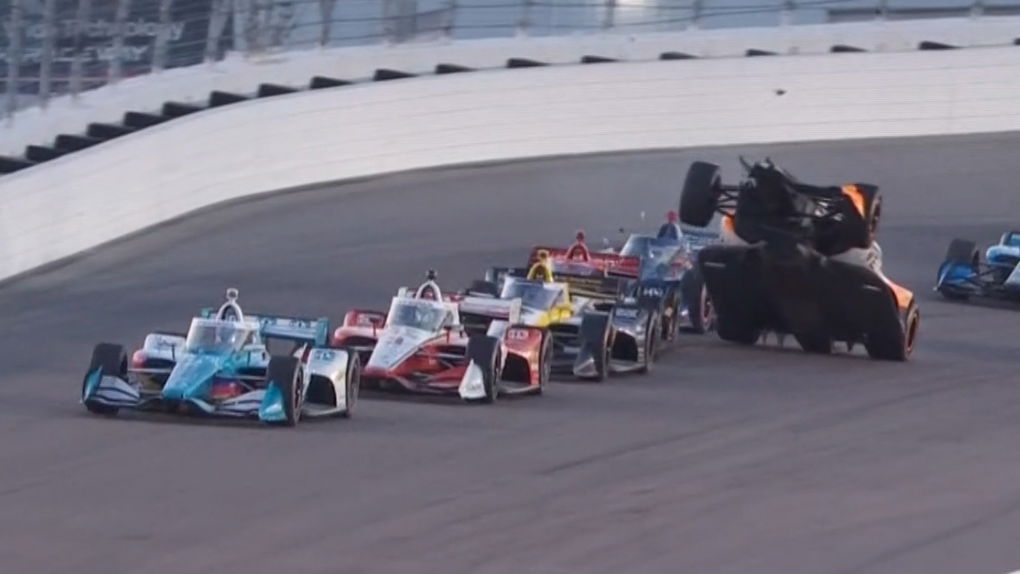 Alexander Rossi climbs over the back of Will Power's car on the second-to-last race restart at Gateway.