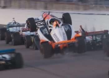 Alexander Rossi climbs over the back of Will Power on the penultimate race restart at Gateway.