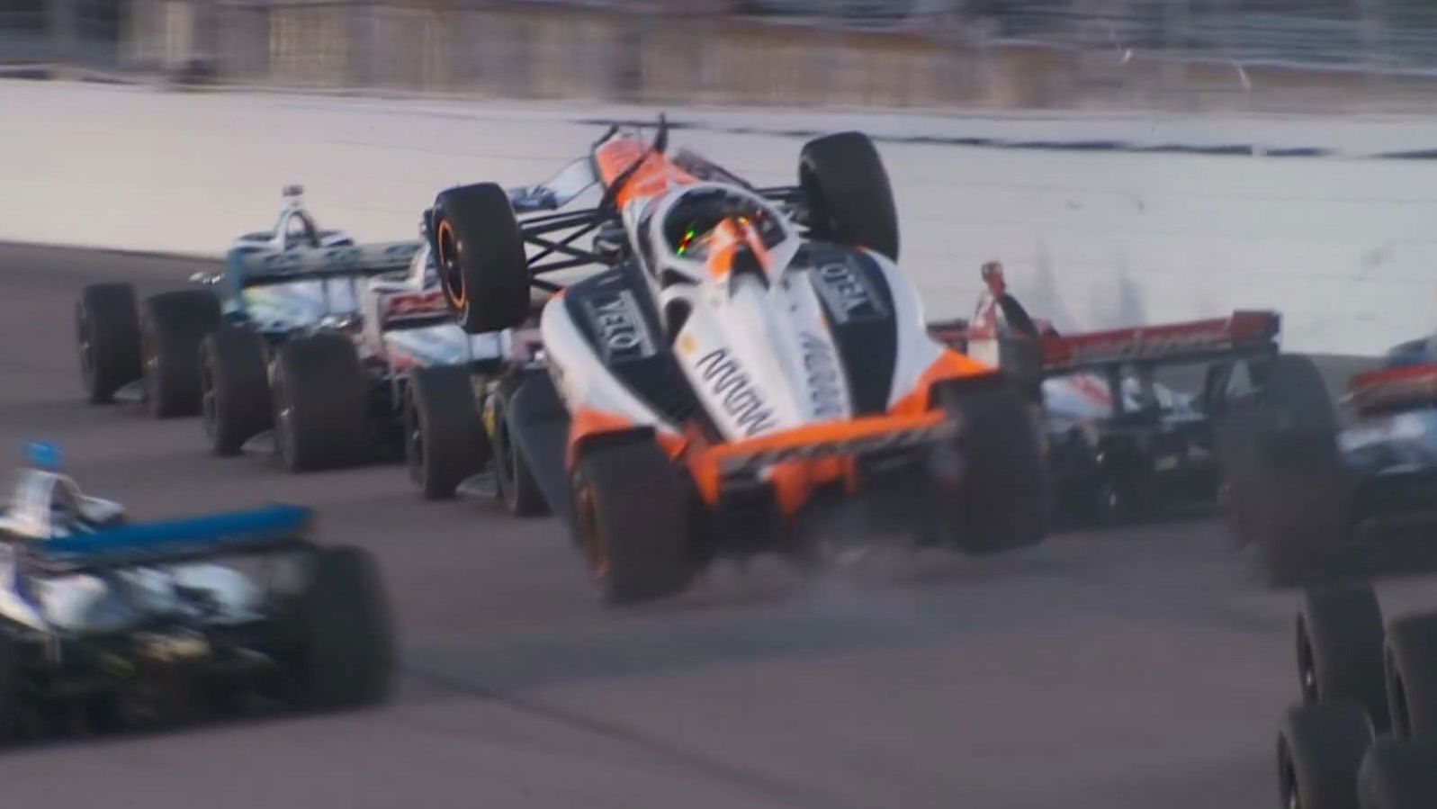 Alexander Rossi climbs over the back of Will Power on the penultimate race restart at Gateway. 