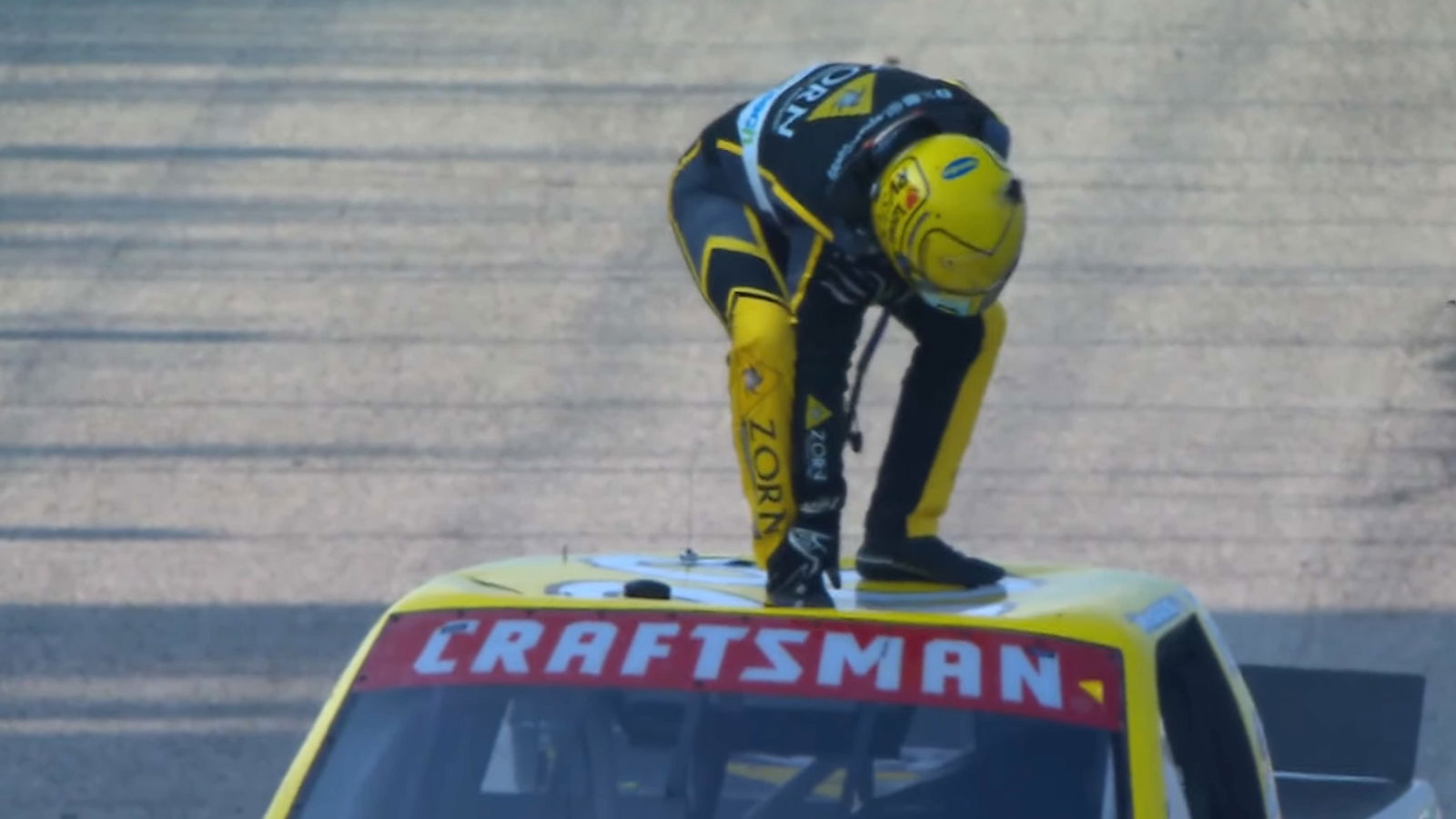 Layne Riggs clutches his shoulder after dislocating it celebrating victory at the Milwaukee Mile.