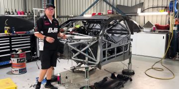 Brad Jones with Jaxon Evans' ruined Chevrolet Camaro.