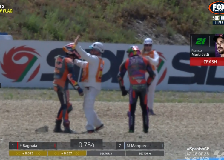 A marshal intervenes as Jack Miller expresses his anger towards Franco Morbidelli after their crash in the Spanish MotoGP Race at Jerez. Image: Fox Sports