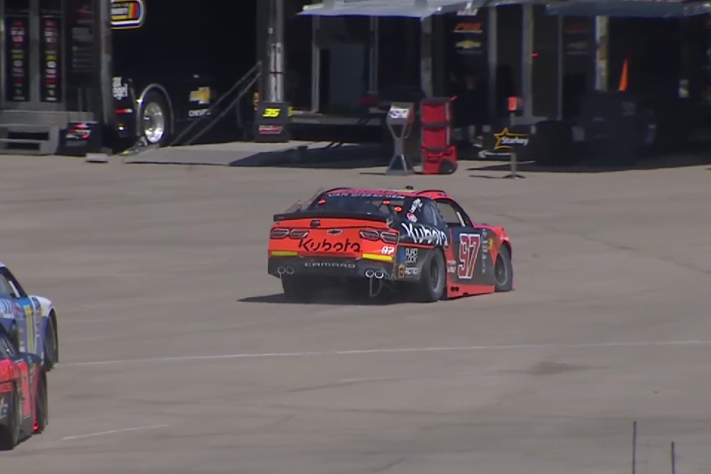 Shane van Gisbergen drives his damaged Camaro back through the paddock after his crash in NASCAR Xfinity Series practice at Iowa Speedway. Image: USA Network/NASCAR