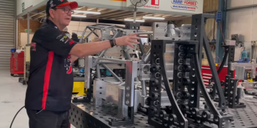 Brad Jones shows the front clip from the R&J Batteries Camaro on the jig. Image: Supplied