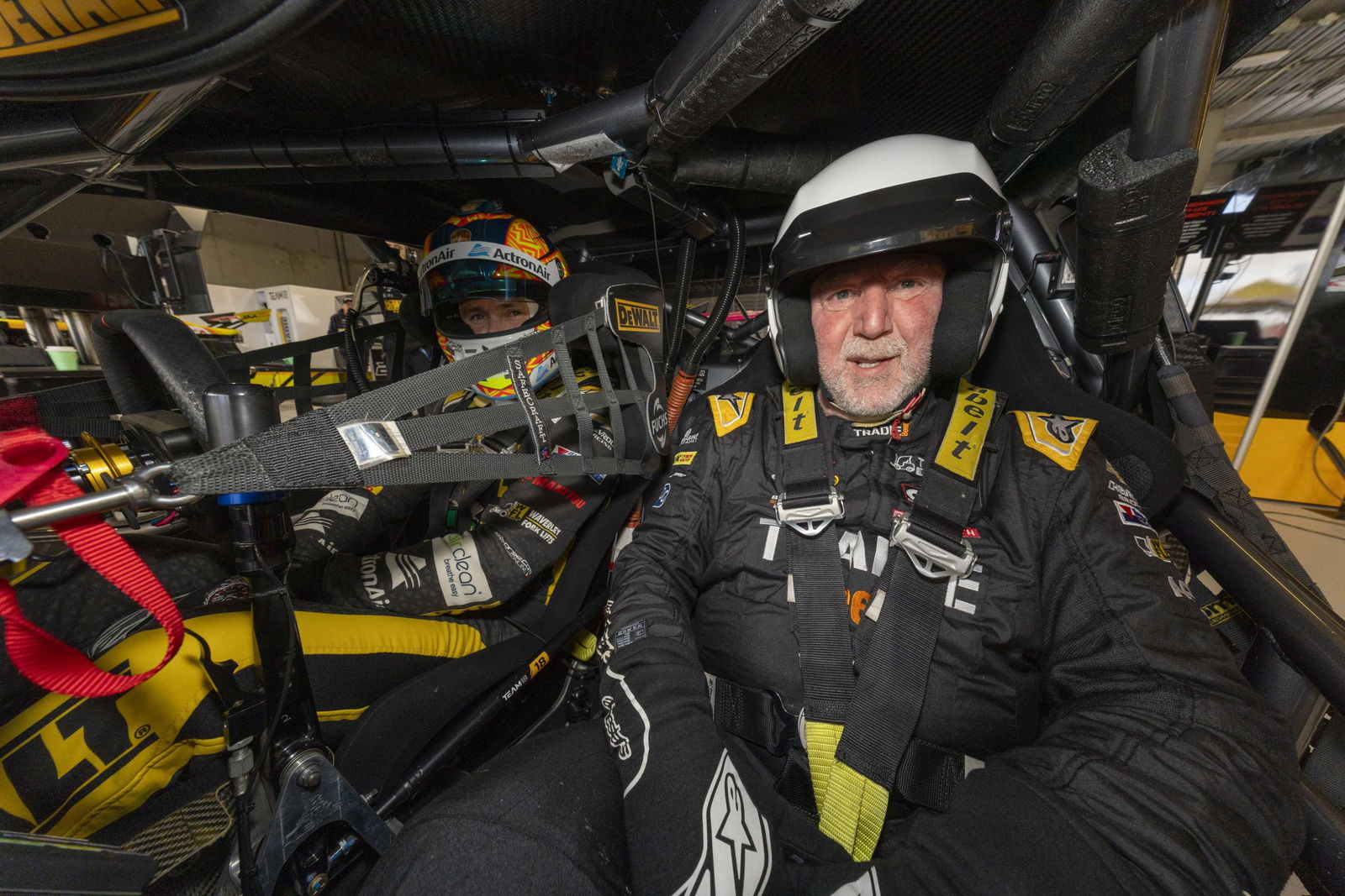 Shane Howard in the passenger seat of the #18 Team 18 Chevrolet Camaro.