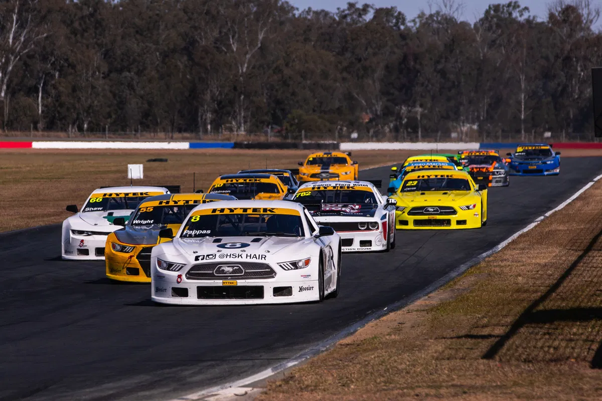 Chris Pappas leads a pack of Trans Am cars in the TA2 Muscle Car Series.